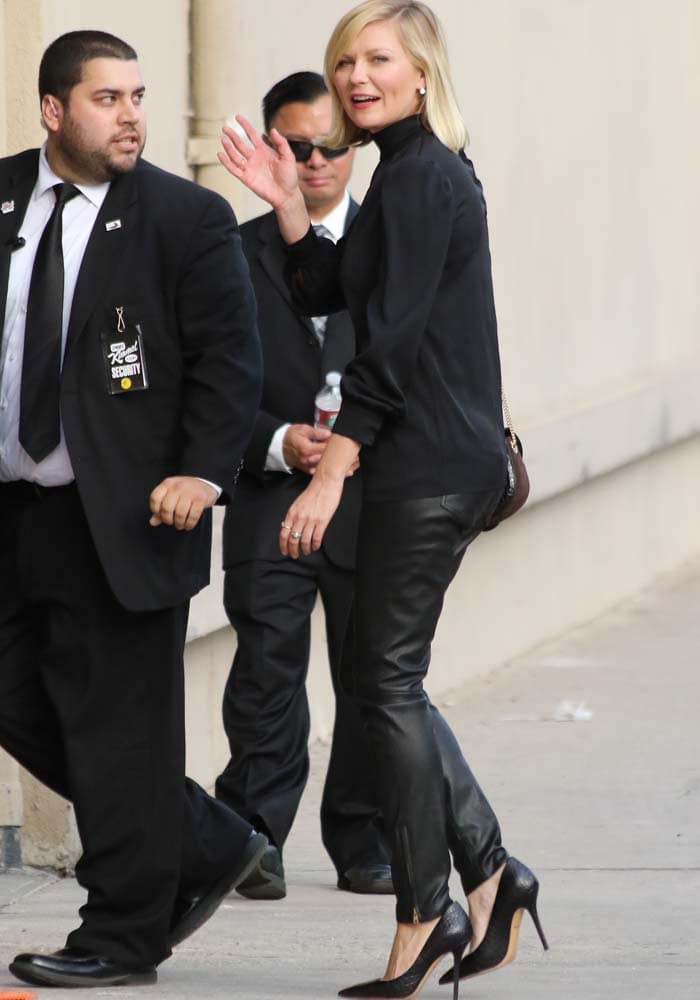 Kirsten Dunst waves to the cameras as she arrives at a Los Angeles studio for an appearance on "Jimmy Kimmel Live!"