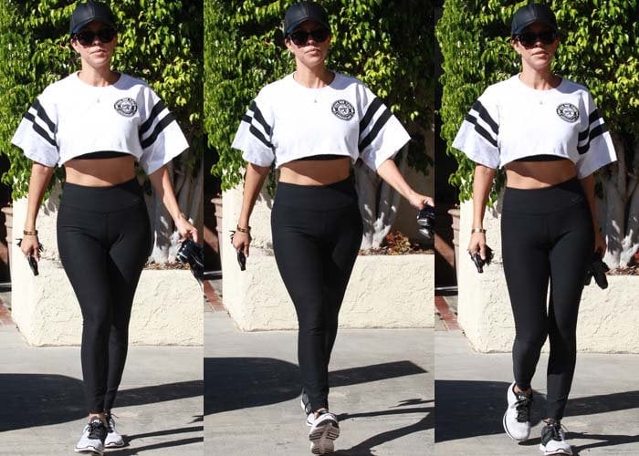 Kourtney Kardashian wears a cropped Reebok top and Nike workout leggings as she runs errands