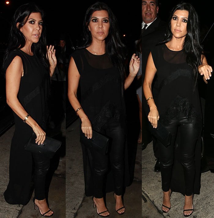 Kourtney Kardashian wears an all-black ensemble and carries a clutch to an art exhibit