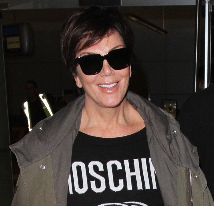 Kris Jenner wearing a printed black Moschino sweater at Los Angeles International Airport