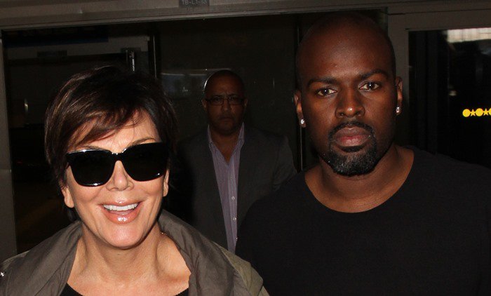 Kris Jenner and Corey Gamble both face the paparazzi as they arrive at LAX