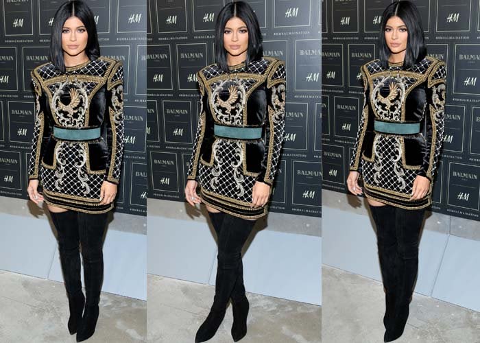 Kylie Jenner pairs an H&M x Balmain dress with a pair of Balmain boots at the launch of the H&M x Balmain collection