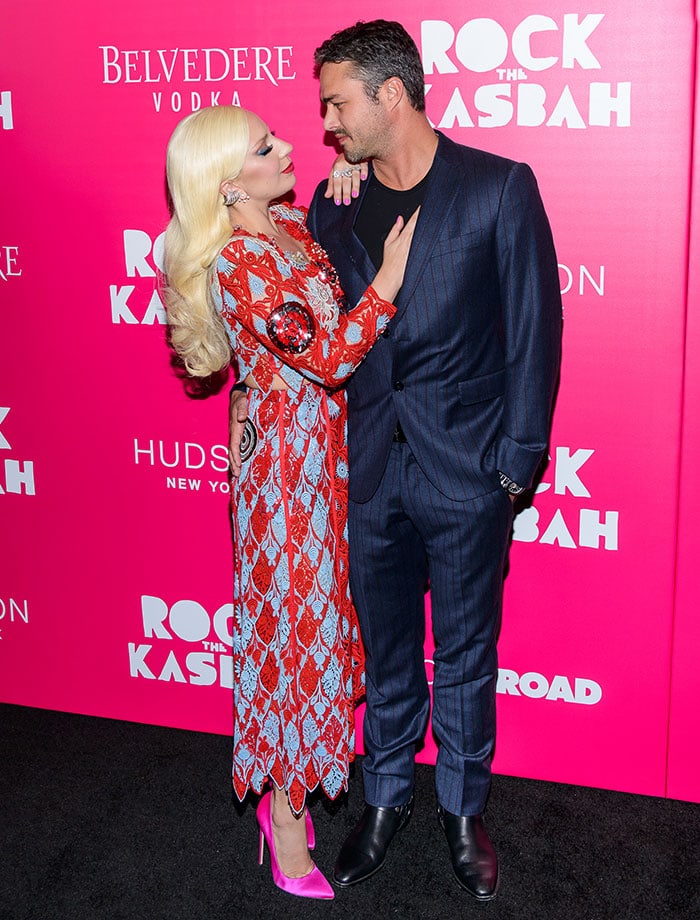 Lady Gaga poses with her hand on fiancé Taylor Kinney's chest at the premiere of "Rock the Kasbah"