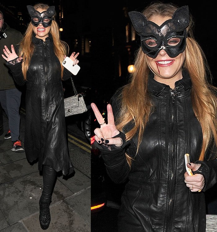 Lindsay Lohan flashes a peace sign while wearing her cat-inspired Halloween costume