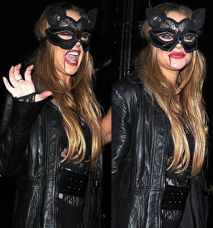 Lindsay Lohan growls while wearing a sexy black leather-and-lace Halloween costume