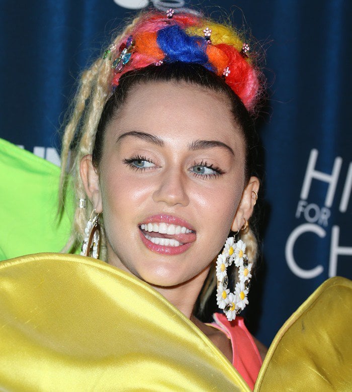 Miley Cyrus shows off her Gasoline Glamour Swan River daisy hoop earrings