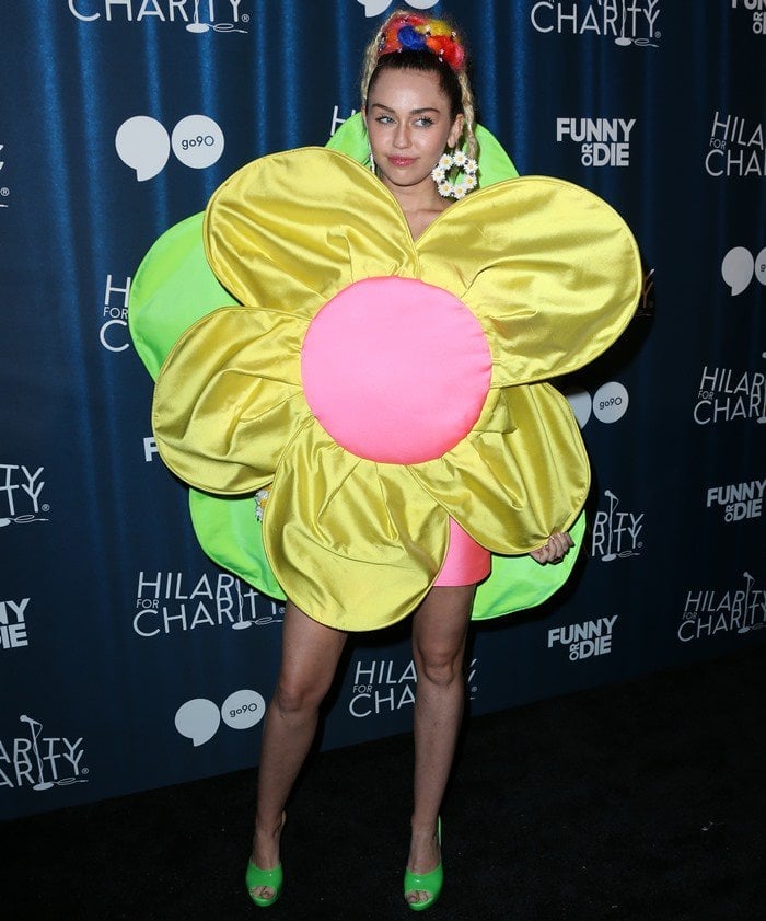 Miley Cyrus posed for the cameras in a flower mini dress from the Agatha Ruiz de la Prada Spring 2013 collection