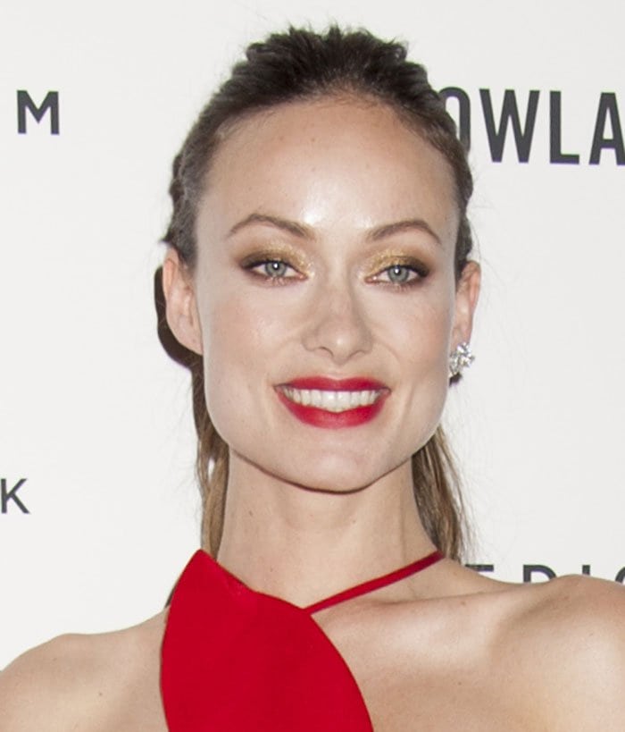 Olivia Wilde styles her hair back and wears bright red lipstick to a special screening of her latest movie