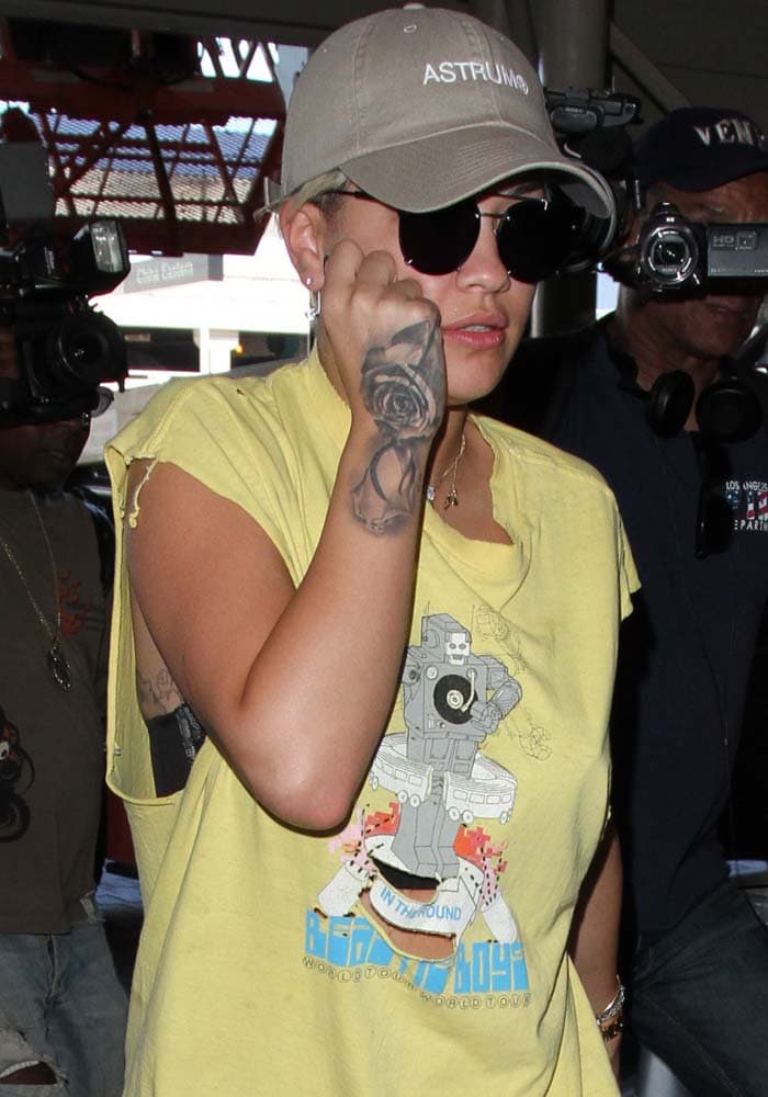 Rita Ora with a black rose tattoo on her right hand
