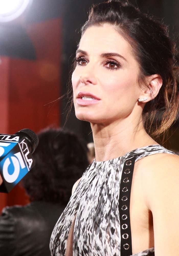 Sandra Bullock wears her hair back during an interview