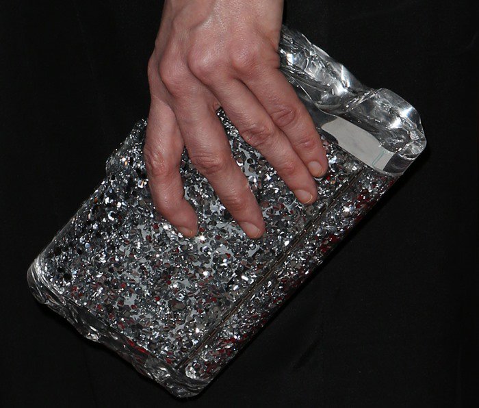 Sarah Silverman carries an Edie Parker clutch in her unmanicured hand