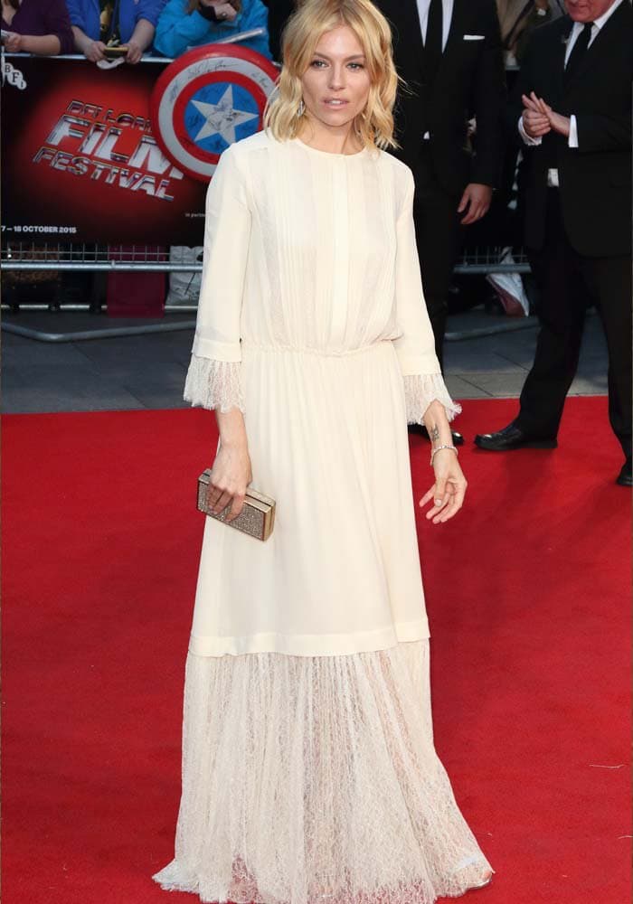 Sienna Miller awkwardly poses on the red carpet for the BFI London Film Festival