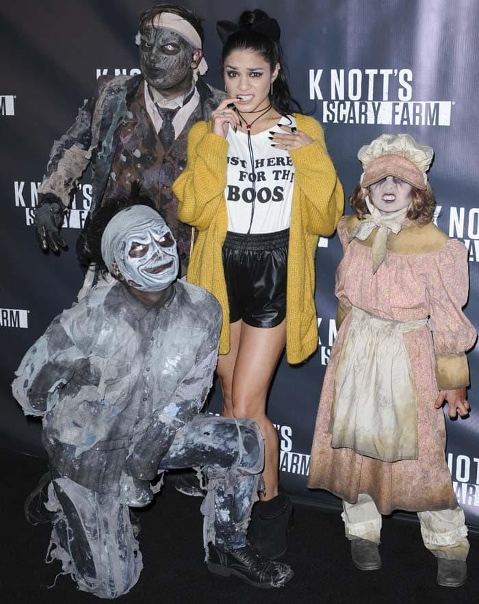 Vanessa Hudgens poses with a pair of cat ears on her hair at a haunted house event