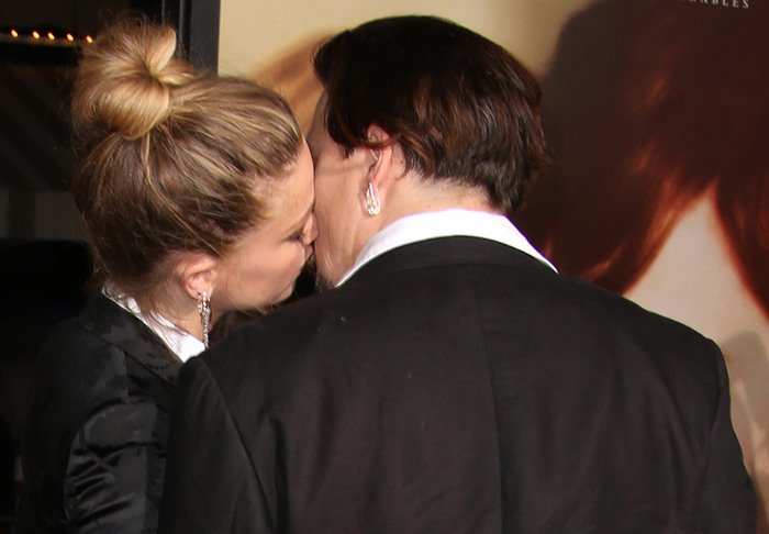 Johnny Depp gets a kiss from Amber Heard at the premiere of her movie The Danish Girl