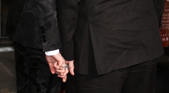 Amber Heard and her much older husband Johnny Depp holding hands