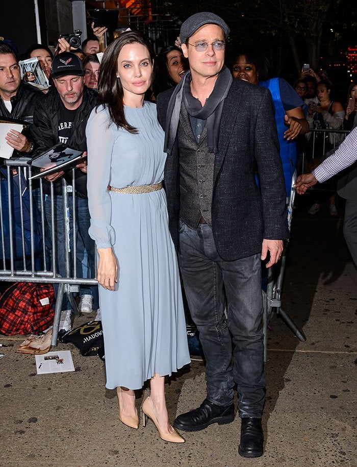 Angelina Jolie poses for photos at the premiere of "By the Sea" with husband Brad Pitt