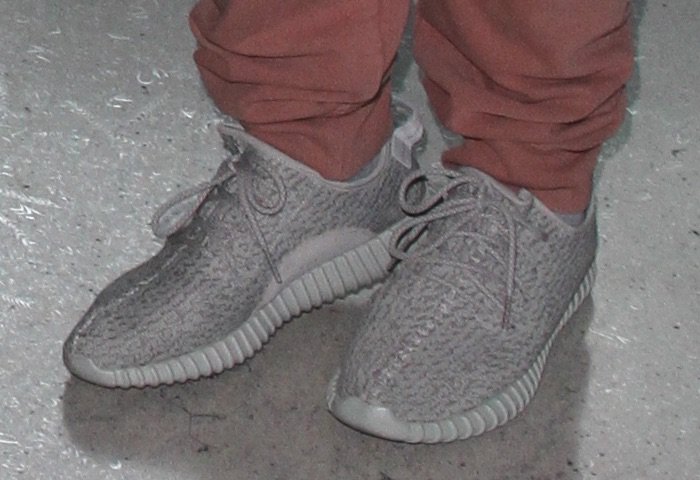 Corey Gamble's feet in Adidas Yeezy Boost 350 sneakers in the Moonrock colorway