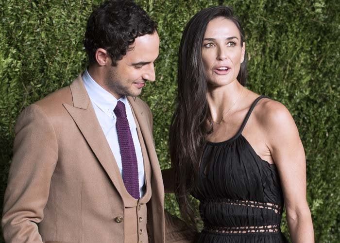 American fashion designer Zac Posen and Demi Moore pose for photos