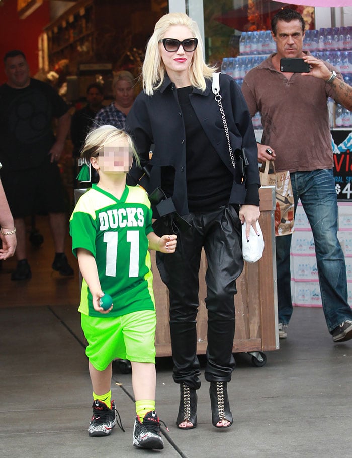 Gwen Stefani wears leather trousers and a black sweater during an outing with her children