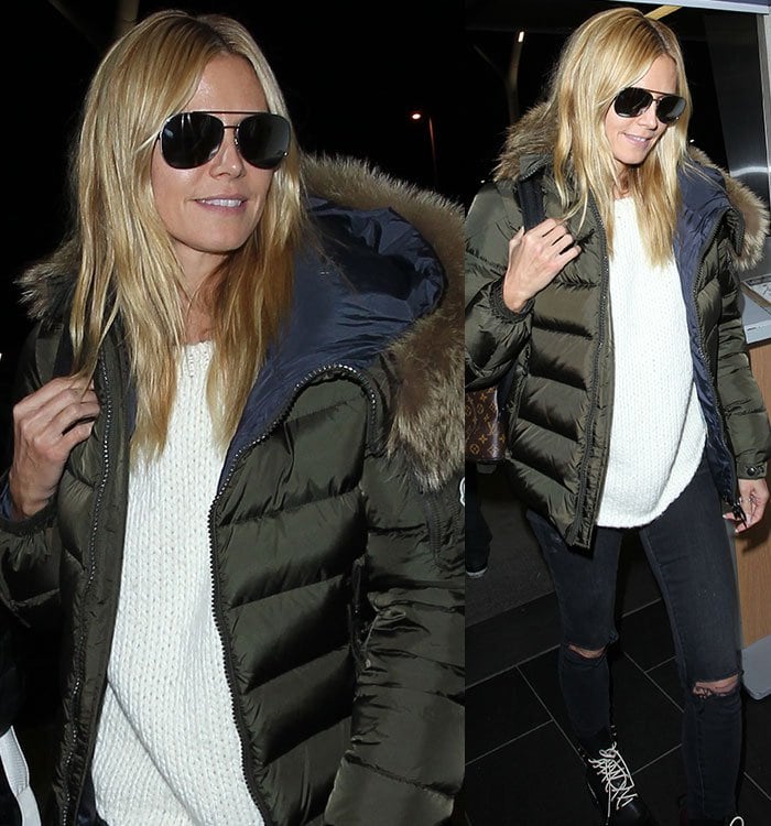 Heidi Klum wears a knit sweater, Moncler parka and ripped jeans at LAX