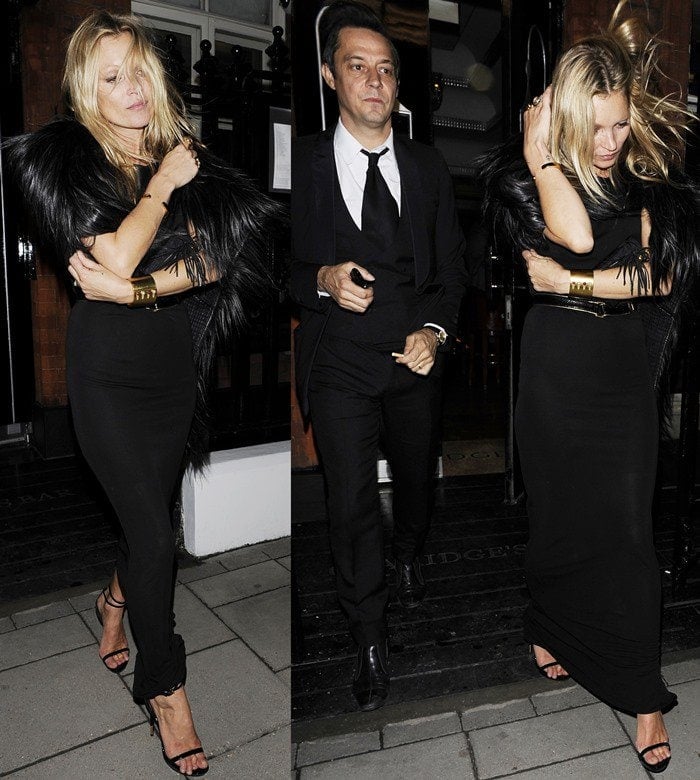 Kate Moss effortlessly rocks an all-black ensemble with a dramatic fur stole and strappy sandals, leaving Claridge’s in London with Jamie Hince by her side
