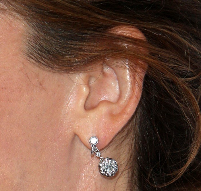 Jennifer Garner's earrings feature a simple round stud connected to a larger round diamond drop, both set in a minimalist metal setting