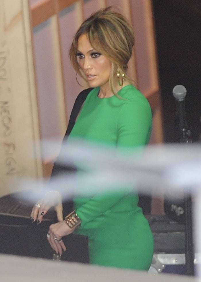 Jennifer Lopez showcased her enviable figure in a modern-looking black-and-green mini dress
