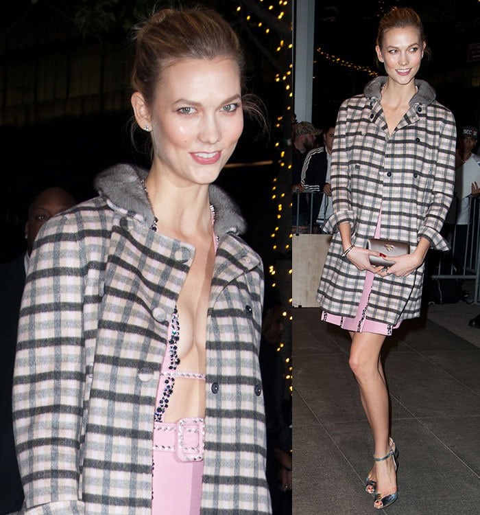 Karlie Kloss smiles in a Prada dress and plaid coat