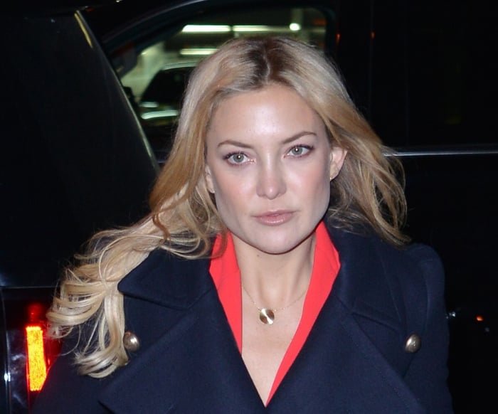 Kate Hudson looks effortlessly chic in a navy Chloe coat paired with a bold red jumpsuit while out in New York City