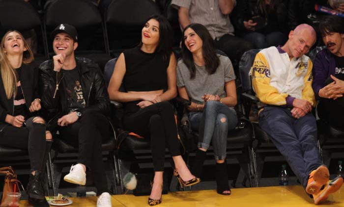 Kendall Jenner watches a basketball game courtside in Gianvito Rossi pumps