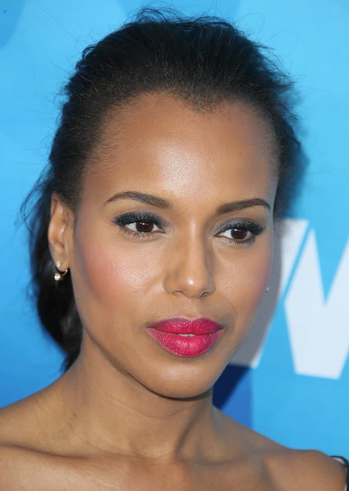 Kerry Washington stuns with a flawless, dewy complexion complemented by bold, vibrant pink lips and subtle, smoky eye makeup