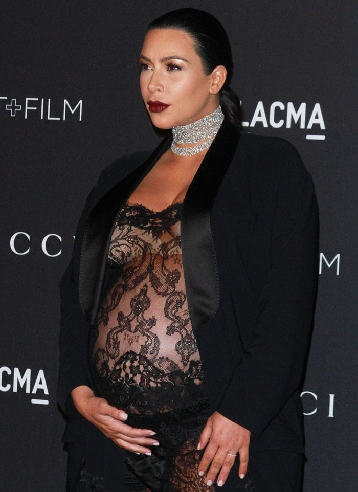 Kim Kardashian in a see-through sheer black lace jumpsuit