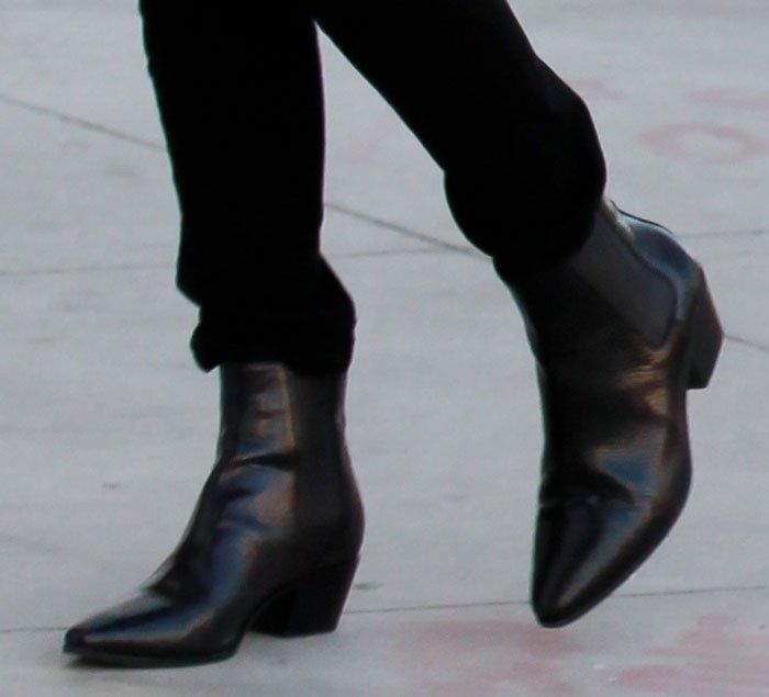 Kourtney Kardashian effortlessly elevates her street style in sleek Saint Laurent Wyatt boots, a timeless staple in luxury footwear