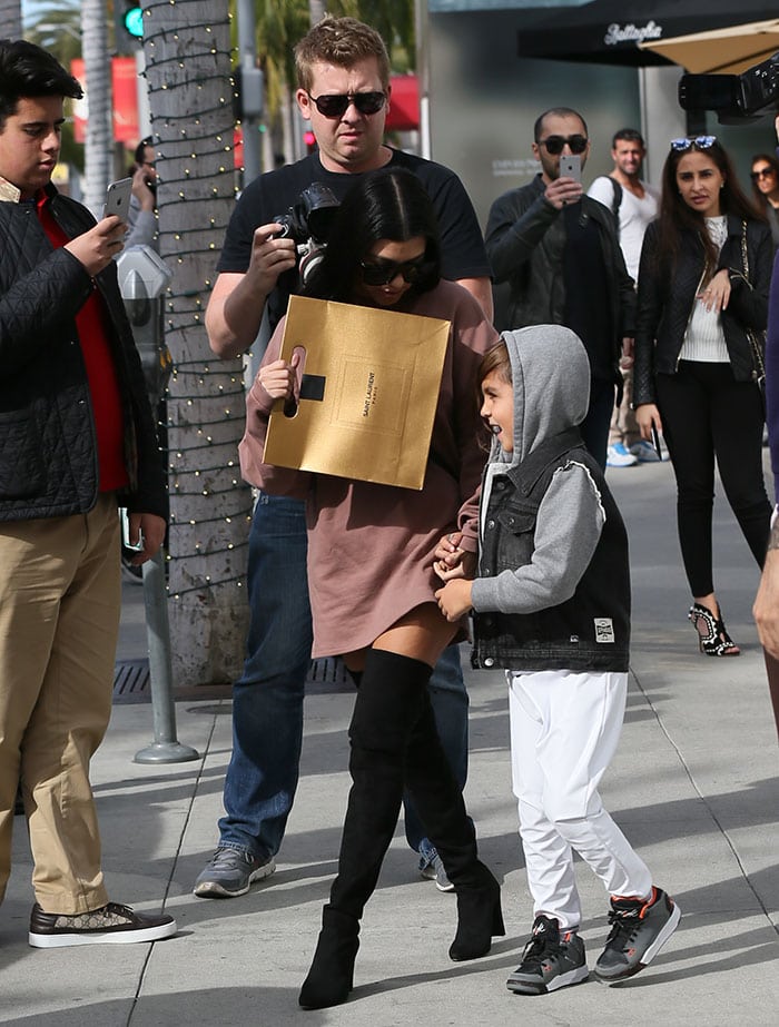 Kourtney Kardashian carries a Yves Saint Laurent shopping bag out in Los Angeles