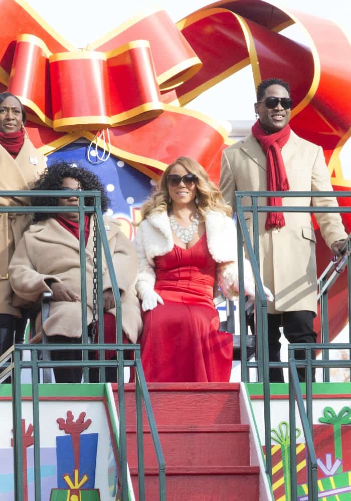 Mariah Carey radiates holiday cheer in a red gown and white shrug, leading the Macy's Thanksgiving Day Parade in New York