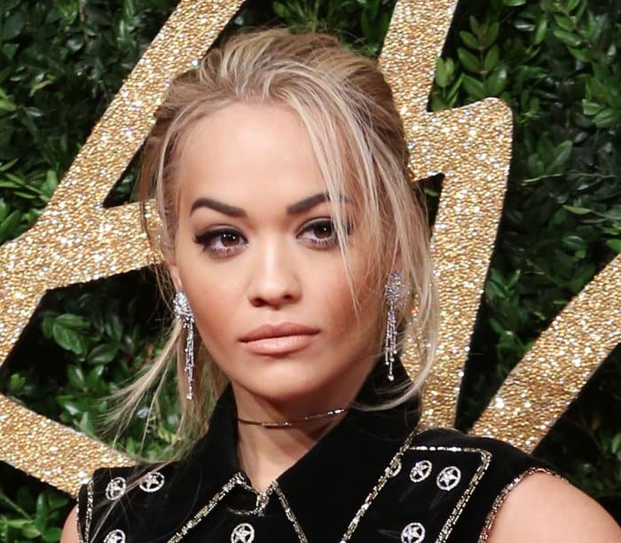 Rita Ora completed her look with a tousled updo and soft, neutral makeup, adding a touch of effortless glamour to her edgy ensemble at the 2015 British Fashion Awards