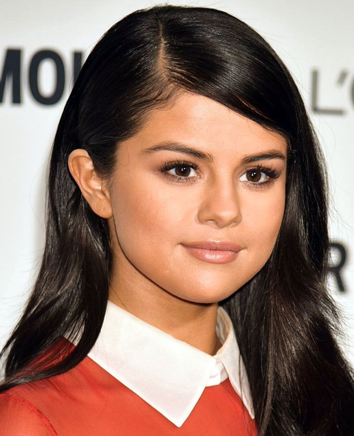 Selena Gomez's dark locks in loose waves with a deep parting