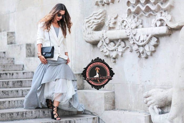 Sofya is a modern-day princess in a blue-gray maxi dress with strappy heels