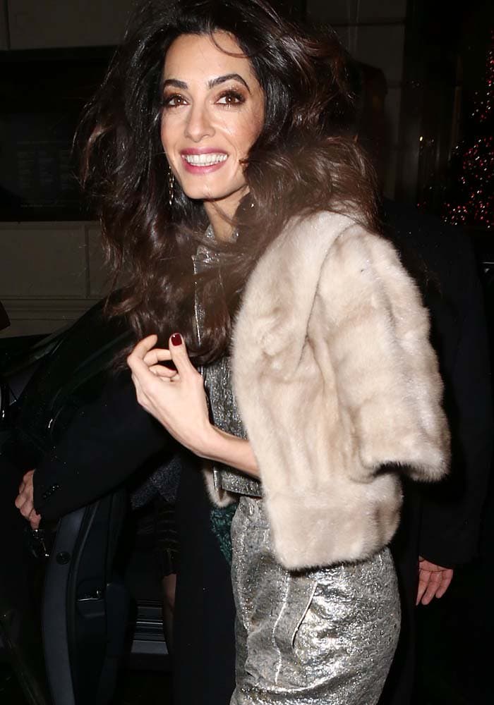 Amal Clooney wore her trademark brown-eyeshadow-and-pink-lip makeup with a hairstyle that was slightly more tousled than her usual