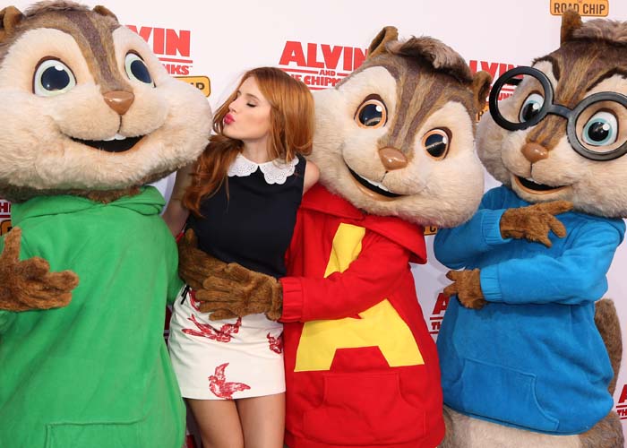 Bella Thorne poses with Alvin and the Chipmunks on the red carpet