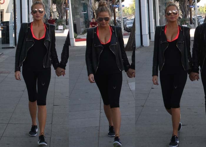 Chrissy Teigen wears a leather jacket over workout clothes during a Los Angeles outing