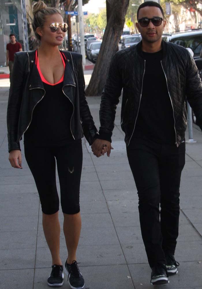 Chrissy Teigen and John Legend go for a walk in matching leather jackets