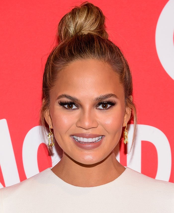 Chrissy Teigen wears her hair in a bun at the launch of Target Wonderland in the meatpacking district of New York City