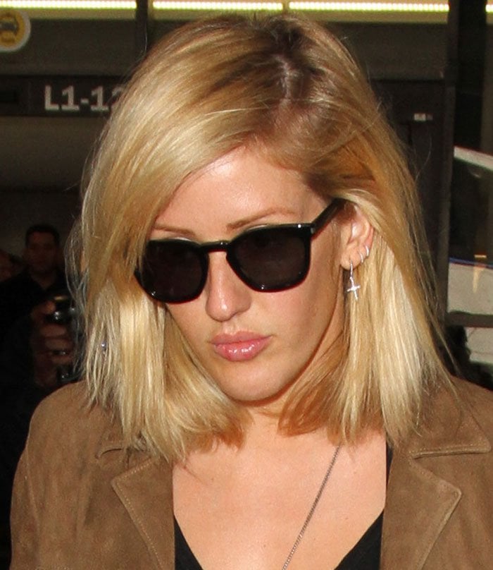 Ellie Goulding wears her blonde hair down as she arrives at Los Angeles International Airport