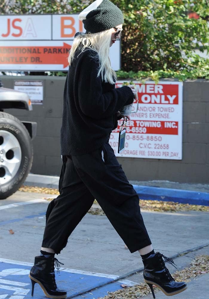 Gwen Stefani wears an all-black ensemble with a pair of L.A.M.B. booties