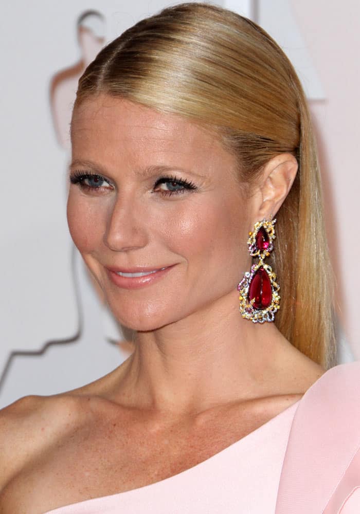 Gwyneth Paltrow with super sleek hair and oversized berry-hued and diamond-encrusted drop earrings