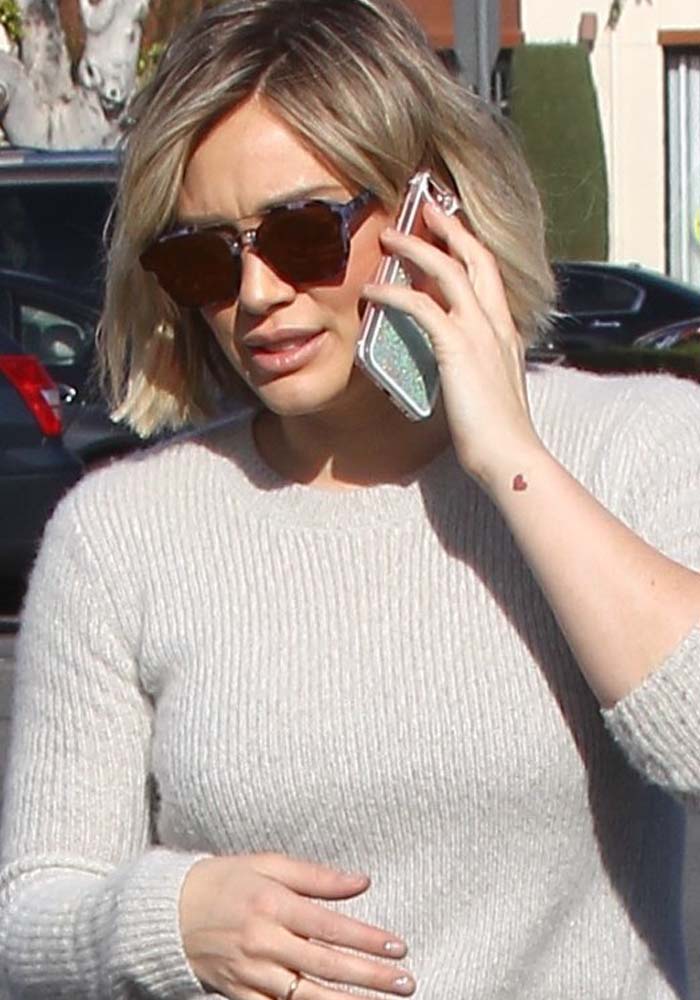 Hilary Duff shows off her heart-shaped tattoo on her left wrist