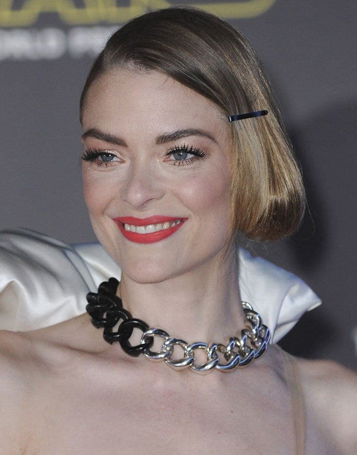 Jaime King clips her hair back at the film premiere of "Star Wars: The Force Awakens"