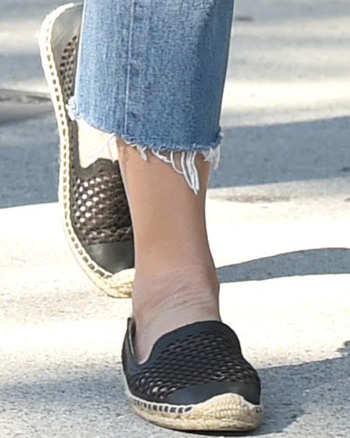 Jenna Dewan steps out in black laser-cut Soludos espadrilles, pairing them with casual cropped denim for a chic and effortless look