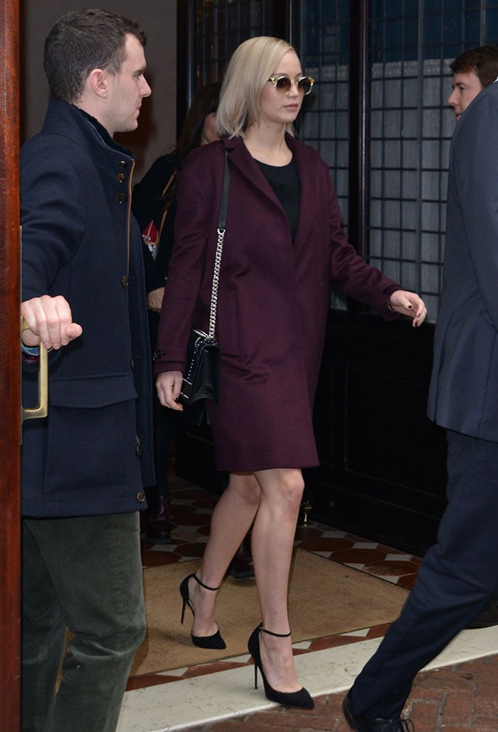 Jennifer Lawrence with sleek, straight hair in an oversized burgundy cashmere coat